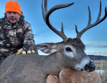A hunter poses with his 4x4 whitetail deer